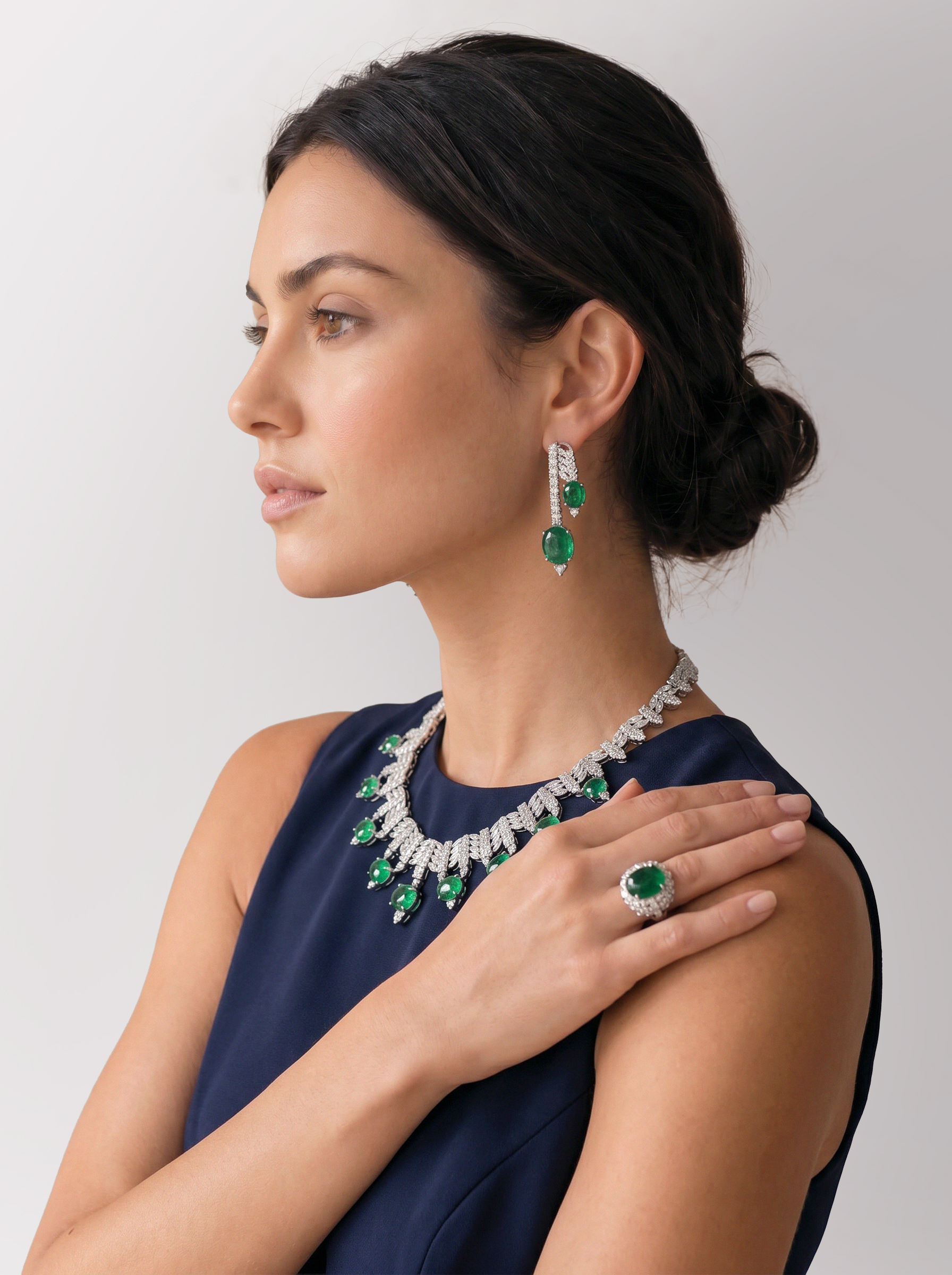 The Emerald Triad, model wearing necklace, earrings and ring